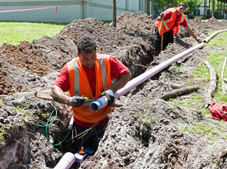 Purple piping is installed to extend a reclaimed water line.